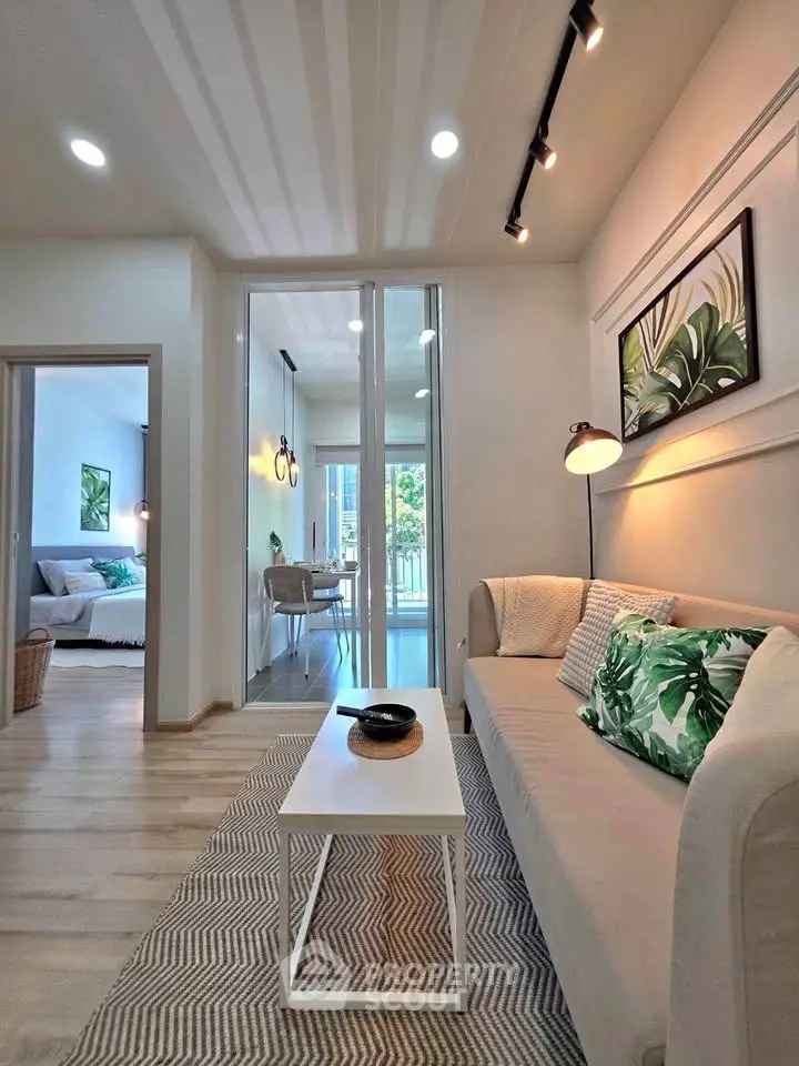 Modern living room with stylish decor and natural light, featuring a cozy sofa and elegant lighting.