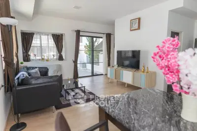 Modern living room with stylish decor and large windows offering natural light