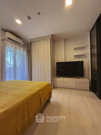 Modern bedroom with stylish decor and large TV unit