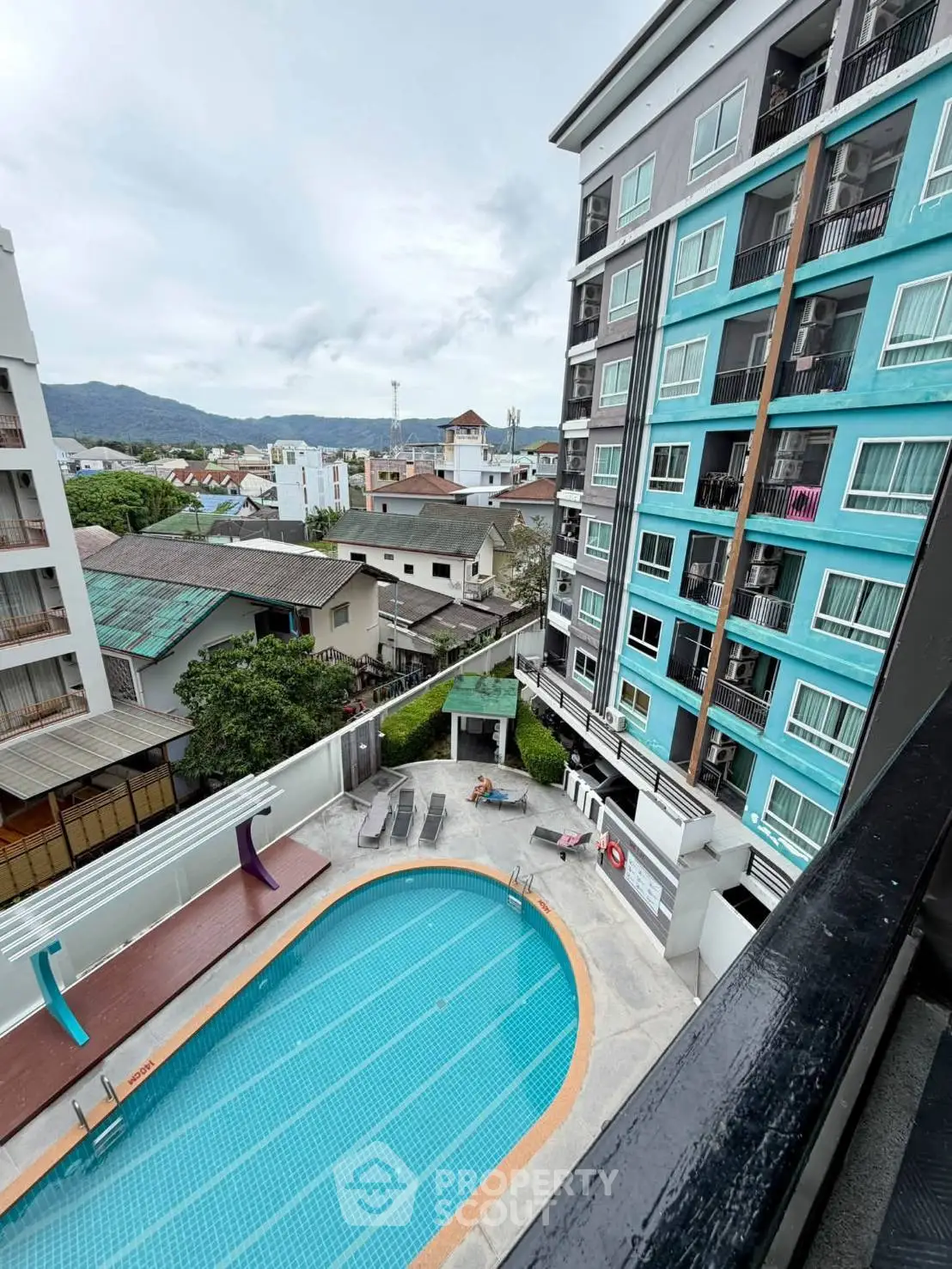 Modern apartment building with pool and city view, ideal for urban living.