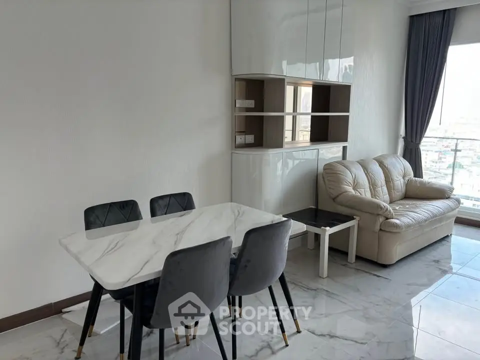 Modern living room with marble floors, stylish dining set, and cozy sofa near a large window.