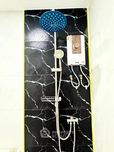 Modern bathroom shower with sleek black marble tiles and water heater