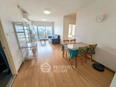 Spacious living room with dining area and balcony view in modern apartment