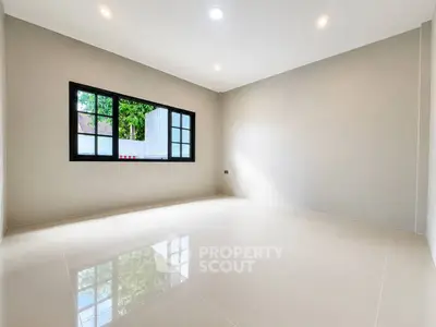 Spacious empty room with large window and glossy tiled floor, perfect for customization.