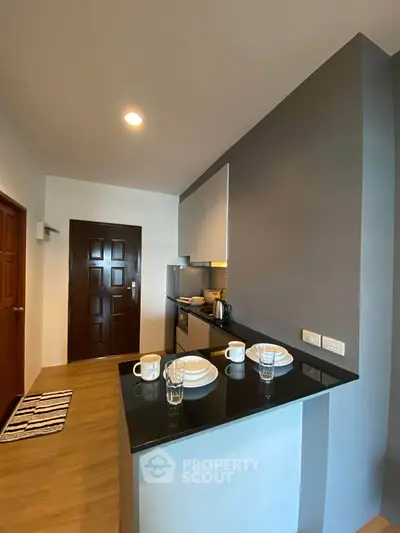 Modern kitchen with sleek design and breakfast bar in cozy apartment