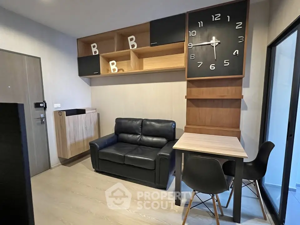 Modern living room with stylish clock and cozy seating area in contemporary apartment.
