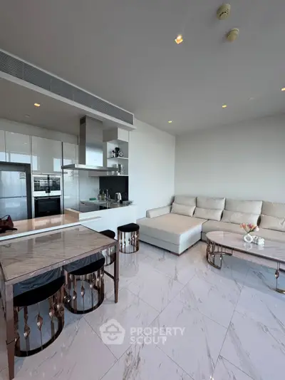 Luxurious modern living room with open kitchen and elegant marble flooring