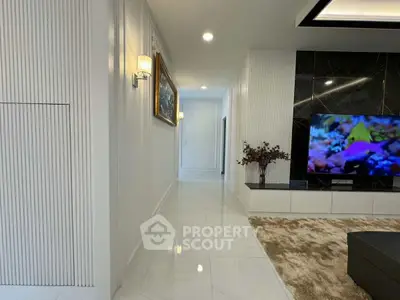 Modern living room with sleek design, large TV, and elegant decor