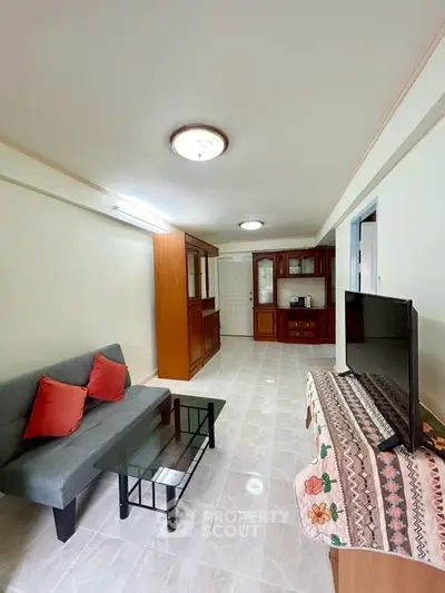 Spacious living room with modern furniture and elegant decor in a well-lit apartment.