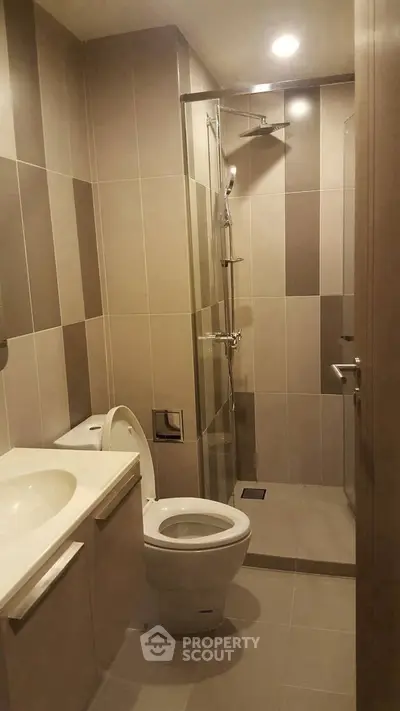 Modern bathroom with sleek design and walk-in shower in a contemporary apartment.