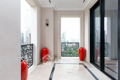 Luxurious balcony with elegant red vases and stunning city view, perfect for relaxation and entertainment.