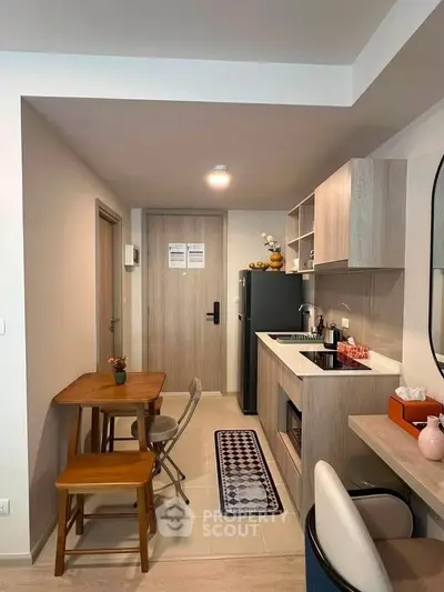 Modern compact kitchen with dining area in stylish apartment