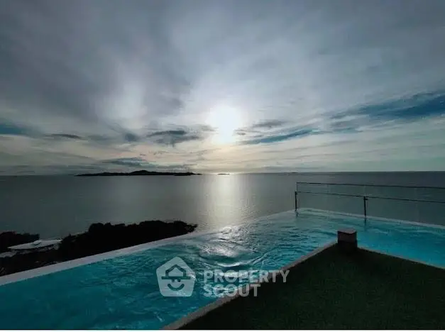 Stunning infinity pool with breathtaking ocean view at sunset