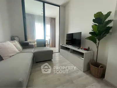 Modern living room with sleek furniture and natural light, perfect for relaxation and entertainment.