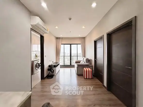 Modern apartment interior with sleek design and city view from the living room.