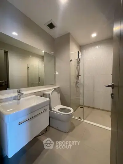 Modern bathroom with sleek fixtures and glass shower enclosure