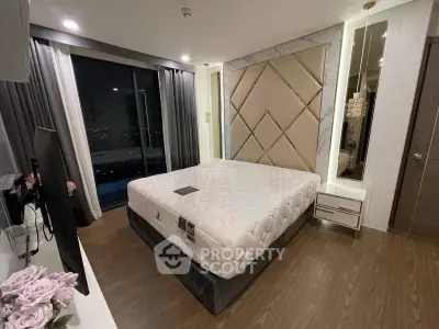 Luxurious bedroom with elegant decor and large window offering stunning city views