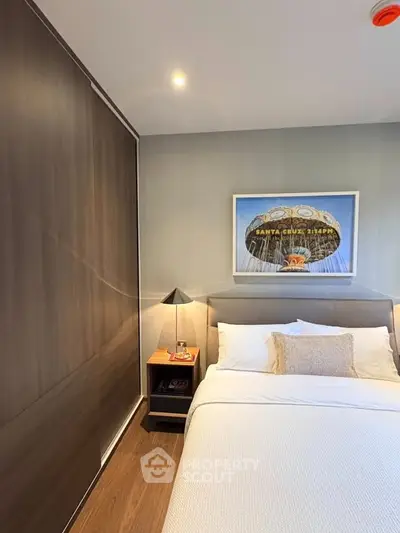Modern bedroom with sleek wardrobe and stylish decor in a cozy apartment.