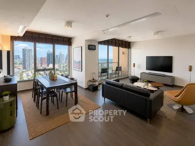 Spacious modern living room with city view, stylish furniture, and large windows in a high-rise apartment.