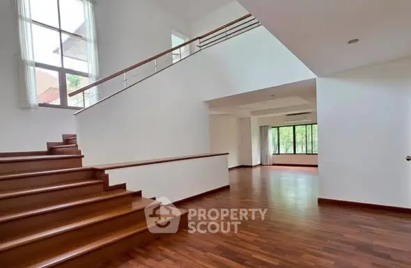 Spacious modern interior with wooden floors and large windows