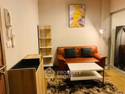 Cozy living room with modern decor, leather sofa, and stylish lighting.