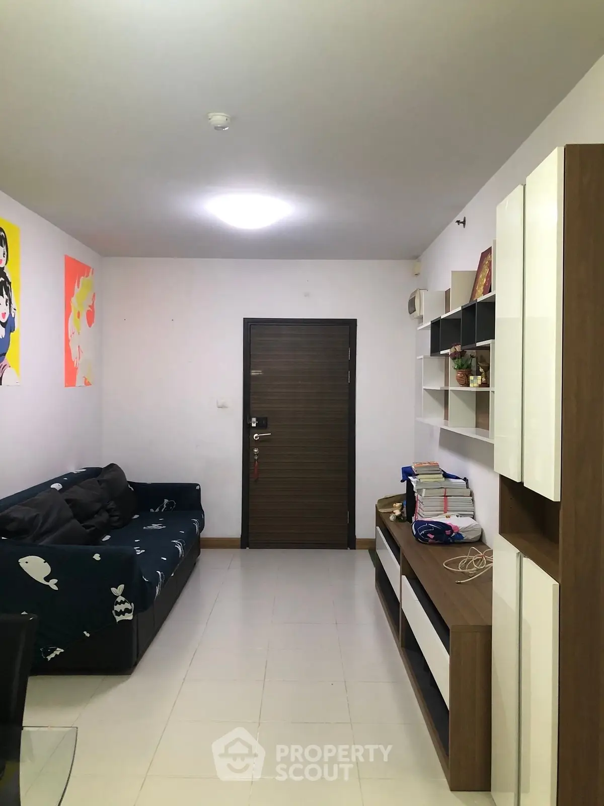 Cozy living room with modern furniture and wall art, perfect for relaxation and entertainment.