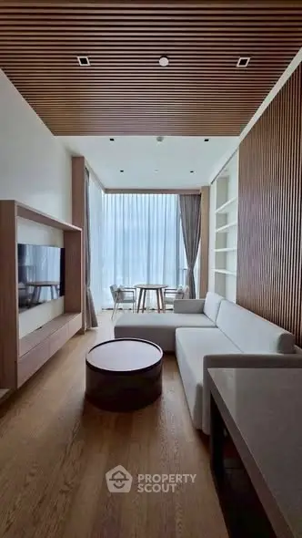 Modern living room with wooden accents and floor-to-ceiling windows