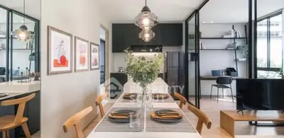 Modern open-plan dining and living area with stylish decor and natural light.