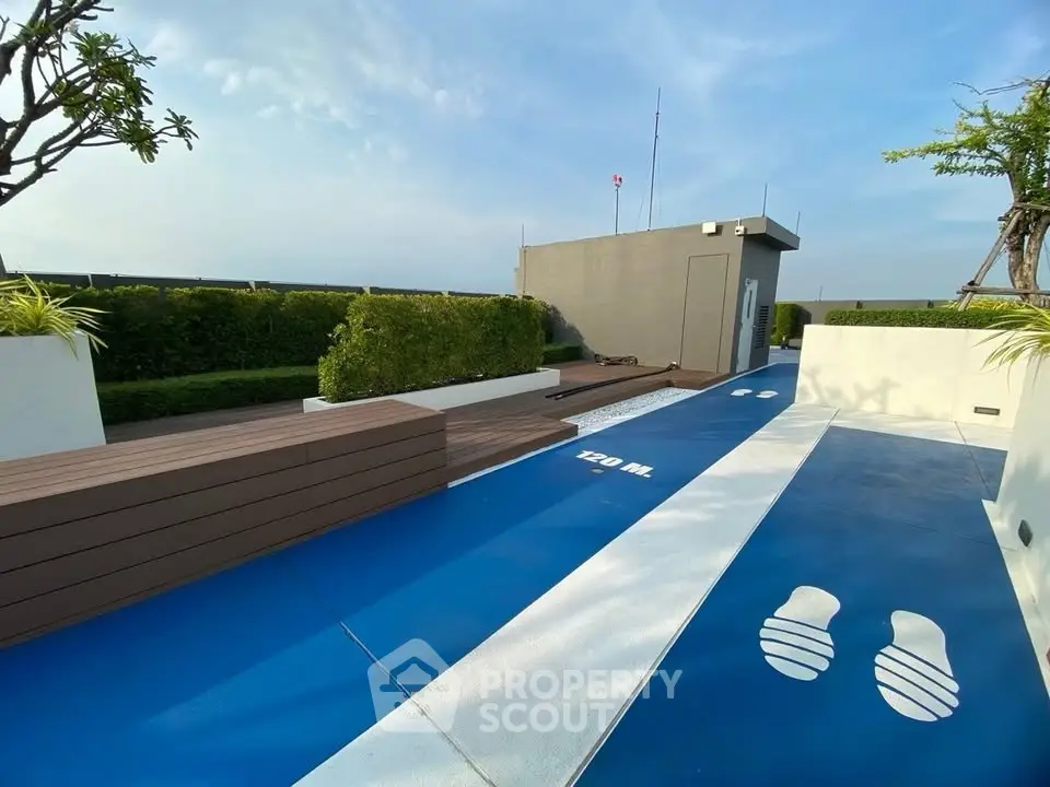 Stunning rooftop area with modern design and lush greenery, perfect for relaxation and leisure activities.