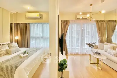 Modern apartment with spacious bedroom and elegant living room, featuring large windows and stylish decor.