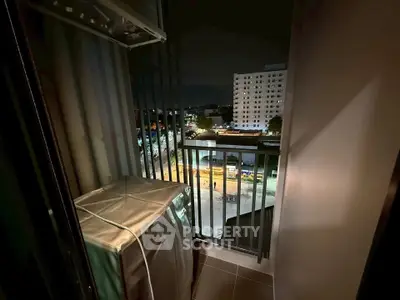 Cozy balcony with city view at night, perfect for relaxation and enjoying urban scenery.