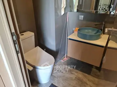 Modern bathroom with sleek fixtures and stylish basin in a contemporary apartment.