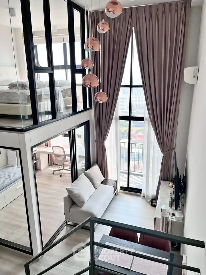 Modern loft apartment with high ceilings, large windows, and stylish decor in a vibrant urban setting.