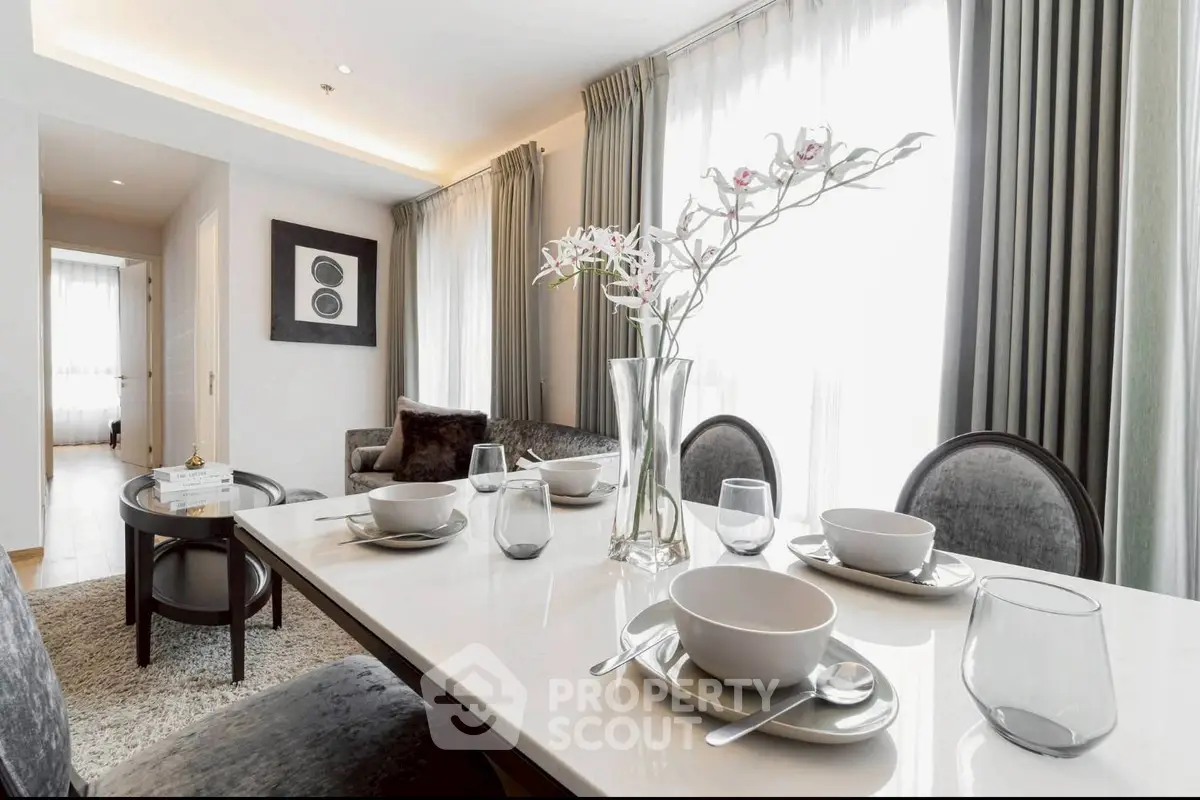 Elegant dining area with modern decor and natural light in a stylish apartment.