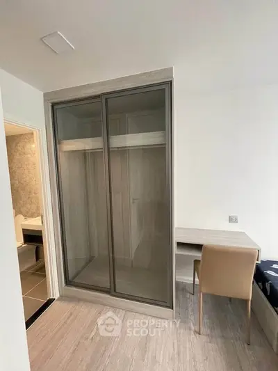 Modern bedroom with sleek wardrobe and study desk, perfect for urban living.