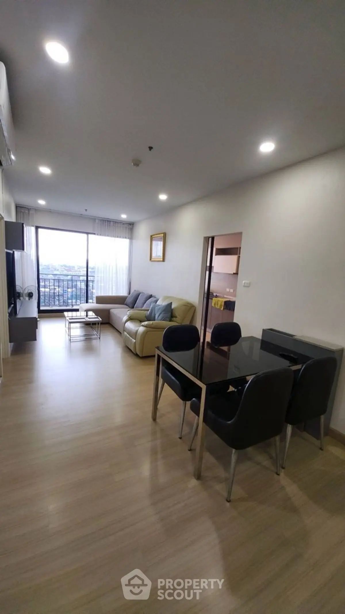 Spacious modern living room with large windows and stylish furniture, offering a cozy and inviting atmosphere.