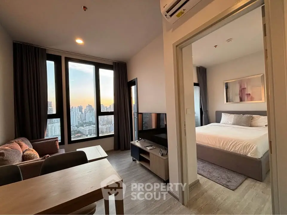Modern apartment with stunning city view, spacious living room, and cozy bedroom, perfect for urban living.