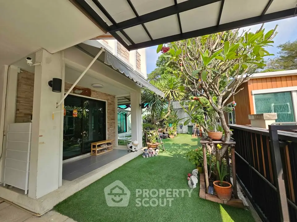 Charming garden view of modern home with lush greenery and spacious outdoor area.