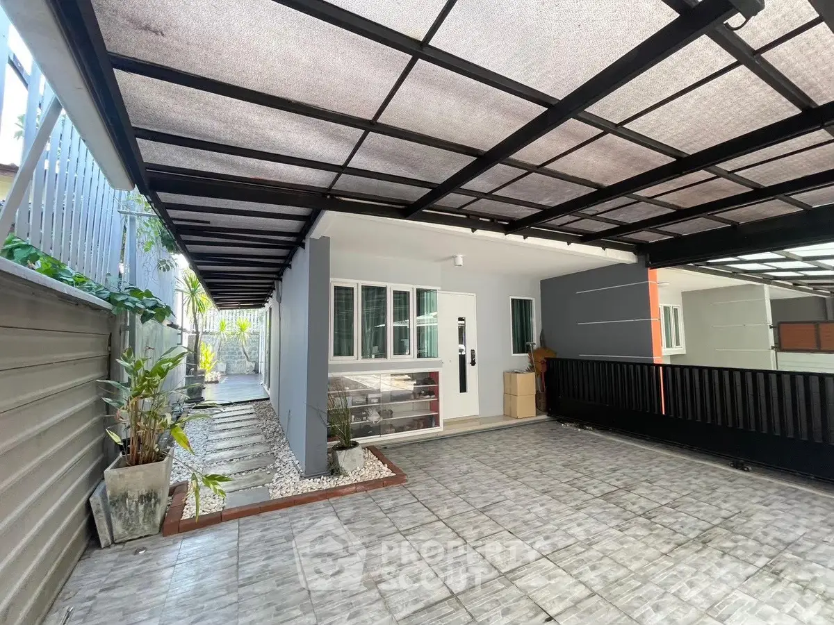 Modern home entrance with covered parking and sleek design