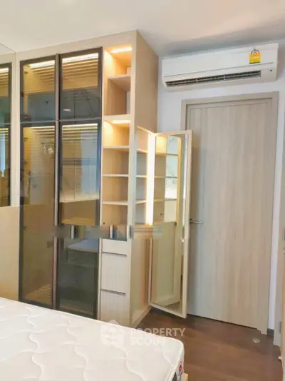 Modern bedroom with built-in wardrobe and air conditioning unit