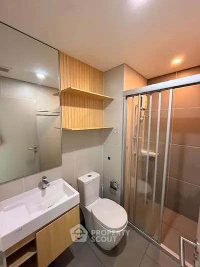 Modern bathroom with sleek fixtures and glass shower enclosure
