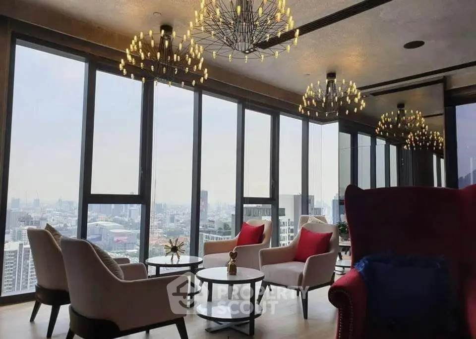 Luxurious high-rise living room with panoramic city views and elegant chandeliers.