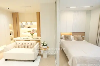 Modern open-plan living room and bedroom with elegant decor and cozy ambiance.