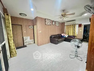 Spacious living room with modern decor and ceiling fan