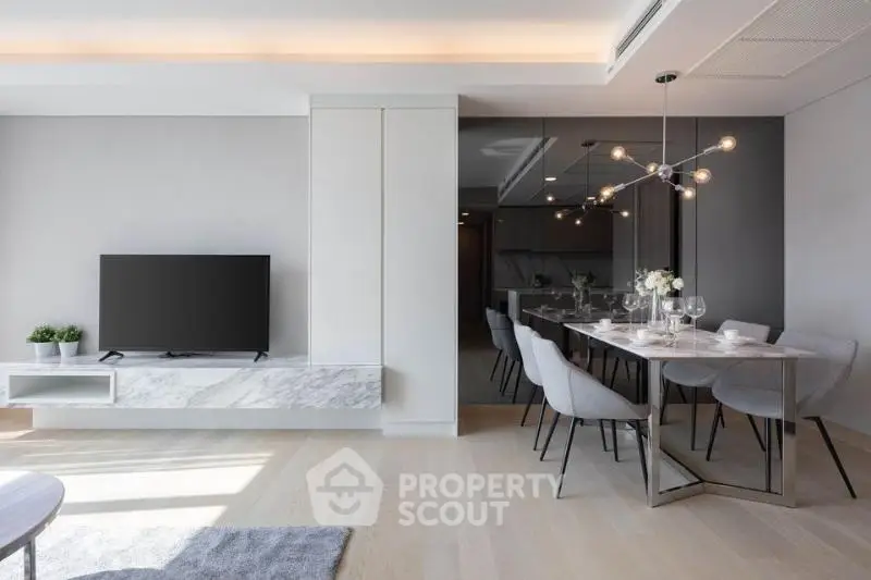 Modern living room with sleek dining area and stylish lighting in a contemporary apartment.