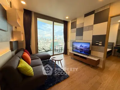 Modern living room with city view, stylish decor, and cozy seating area in high-rise apartment.