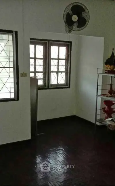 Cozy interior room with window and wall-mounted fan, ideal for customization.