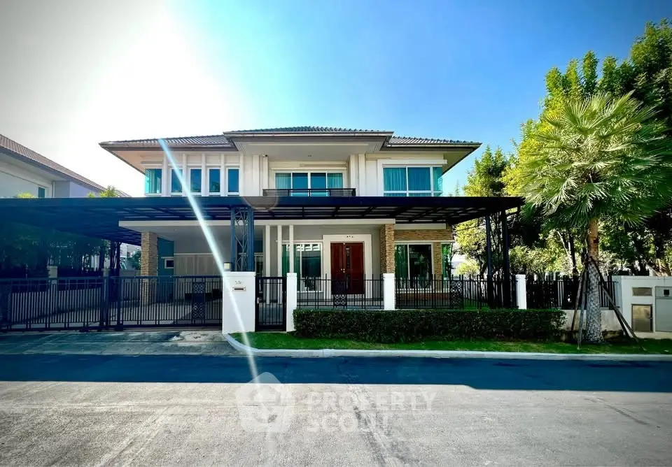 Stunning modern two-story house with lush greenery and spacious driveway in a serene neighborhood.
