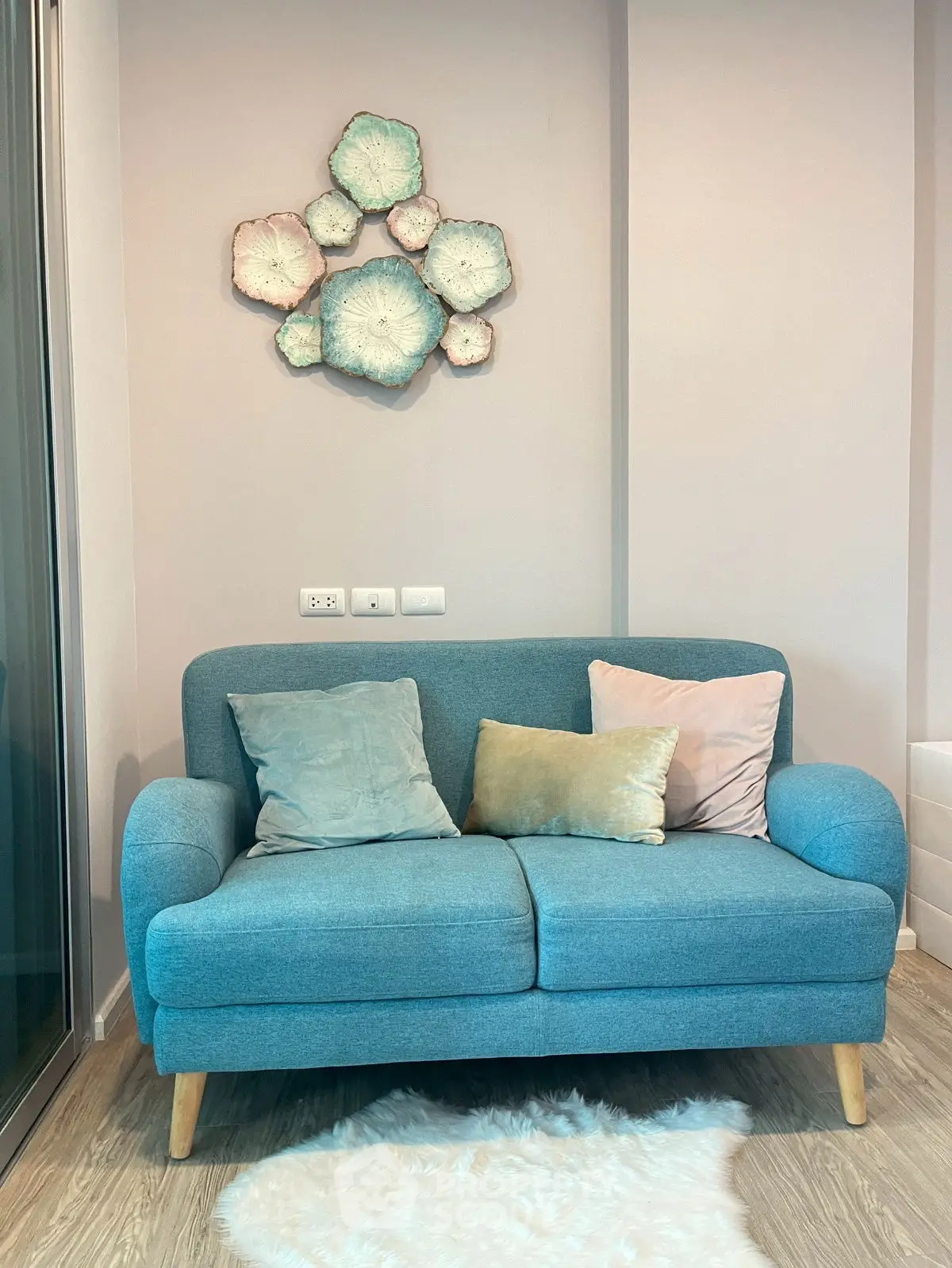 Cozy living room with stylish blue sofa and decorative wall art