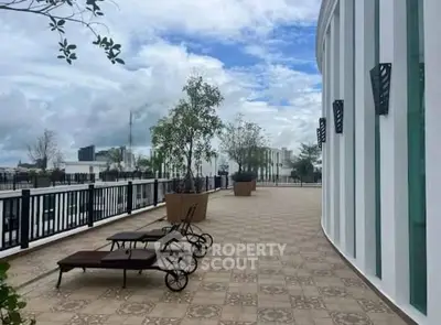 Spacious rooftop terrace with lounge chairs and scenic city views.